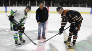 hockey night in claresholm - The Claresholm Cowboys began their inaugural season in the United States Premier Hockey League on Saturday night, Sept. 26, at Claresholm Arena. Here Claresholm Mayor Brad Schlossberger drops the puck for the ceremonial opening face off between Claresholm Captain Dustyn Stoesz, at right, and Three Hills Captain Blake O'Dempsey, at left. Photo by Rob Vogt